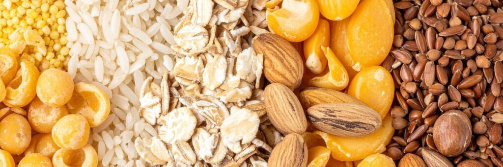 A close-up mix of nutritional seeds and grains showing almonds, flaxseeds, oats, and millet for natural health benefits.