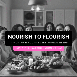 A diverse group of women of different ages and ethnicities gathered in a bright kitchen, smiling and enjoying a table full of iron-rich foods including spinach, lentils, tofu, quinoa, pumpkin seeds, chickpeas, and dark chocolate. Natural light fills the room, and a small “Happy Women’s Day” sign is visible. Text overlay on a mauve banner reads: "NOURISH TO FLOURISH – 7 Iron-Rich Foods Every Woman Needs on International Women’s Day.